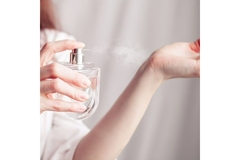 A lady spraying fragrance on her pulse